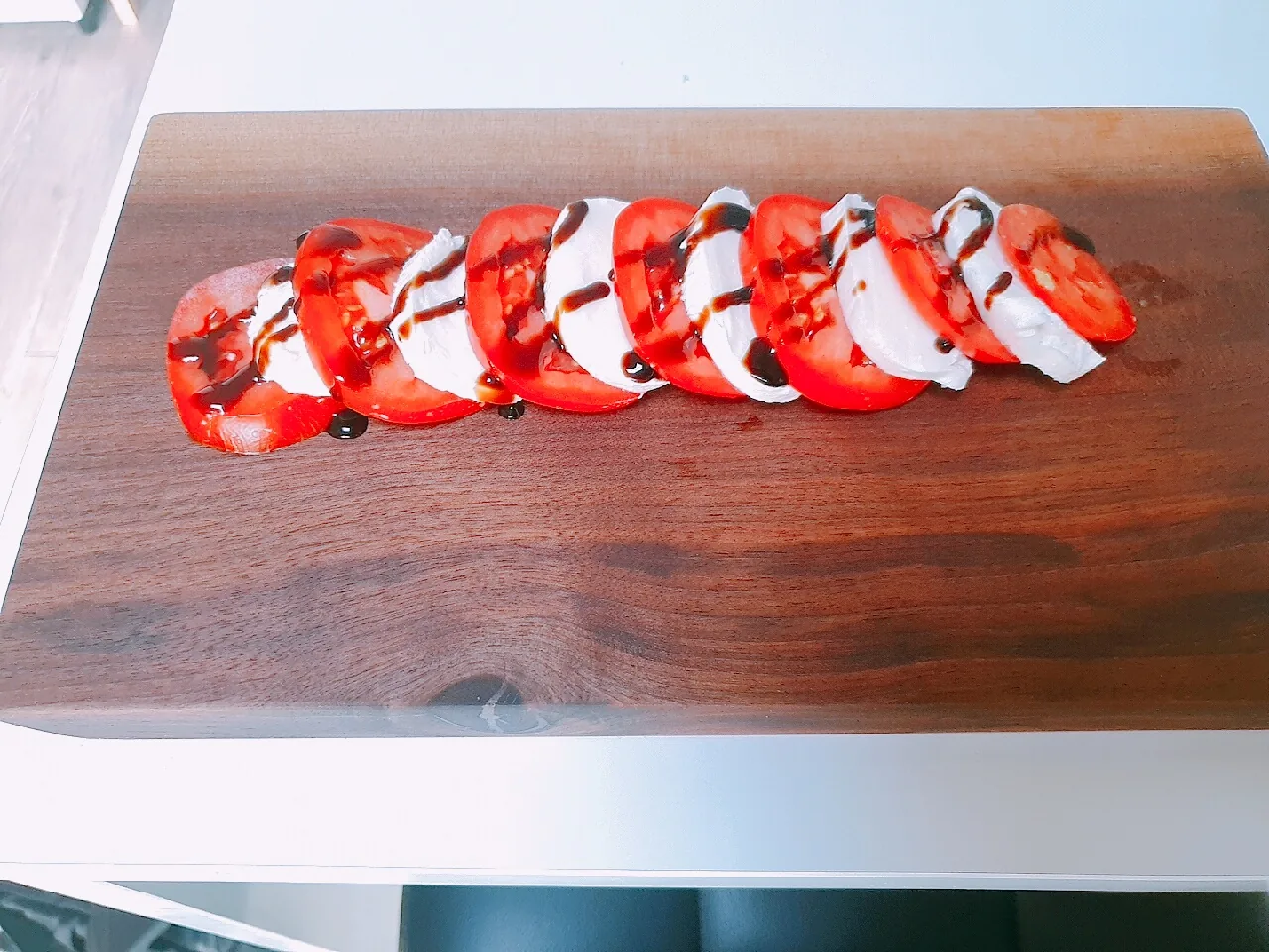 Caprese with alternating slices of tomato and mozzarella
