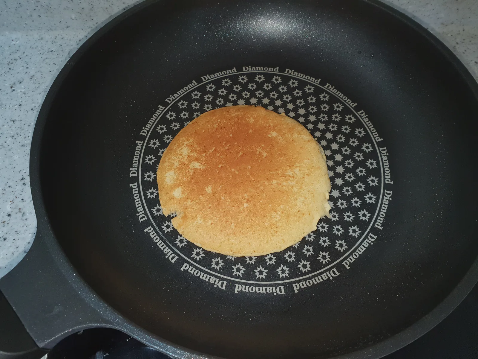 A pancake cooking in a pan
