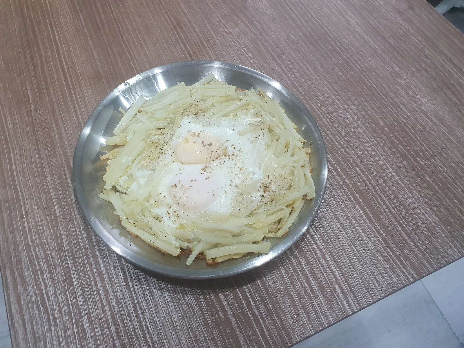A second potato nest pancake topped with egg