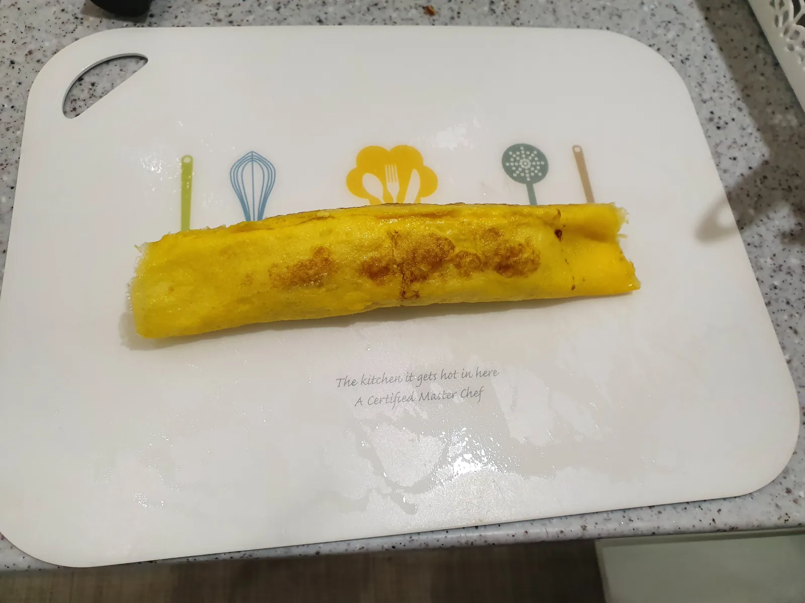 A rolled omelet on a cutting board