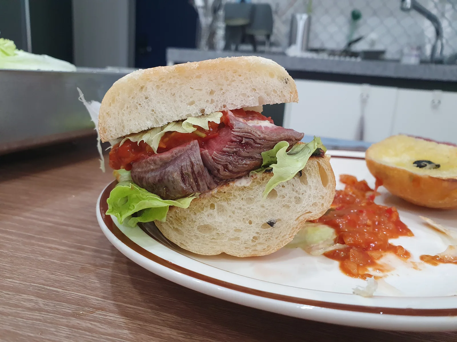 A steak sandwich with tomato relish