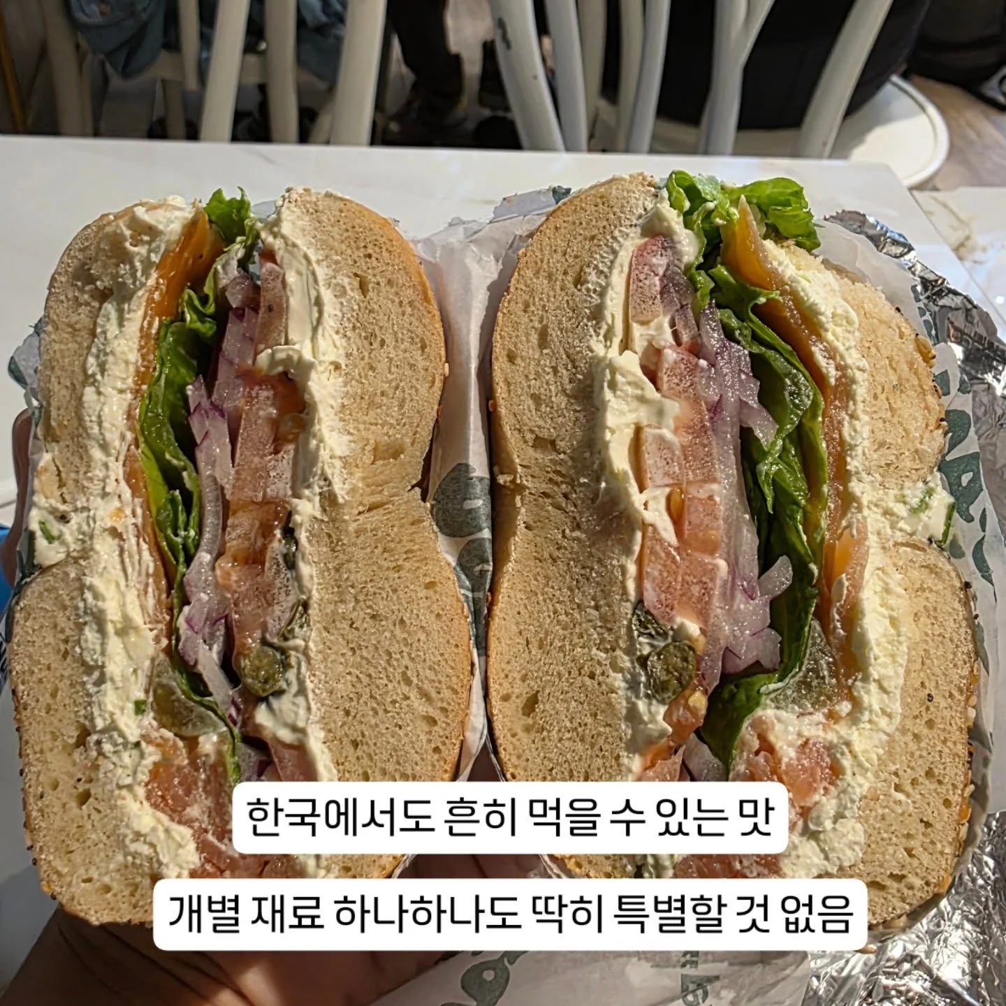 A filled bagel sandwich cut in half