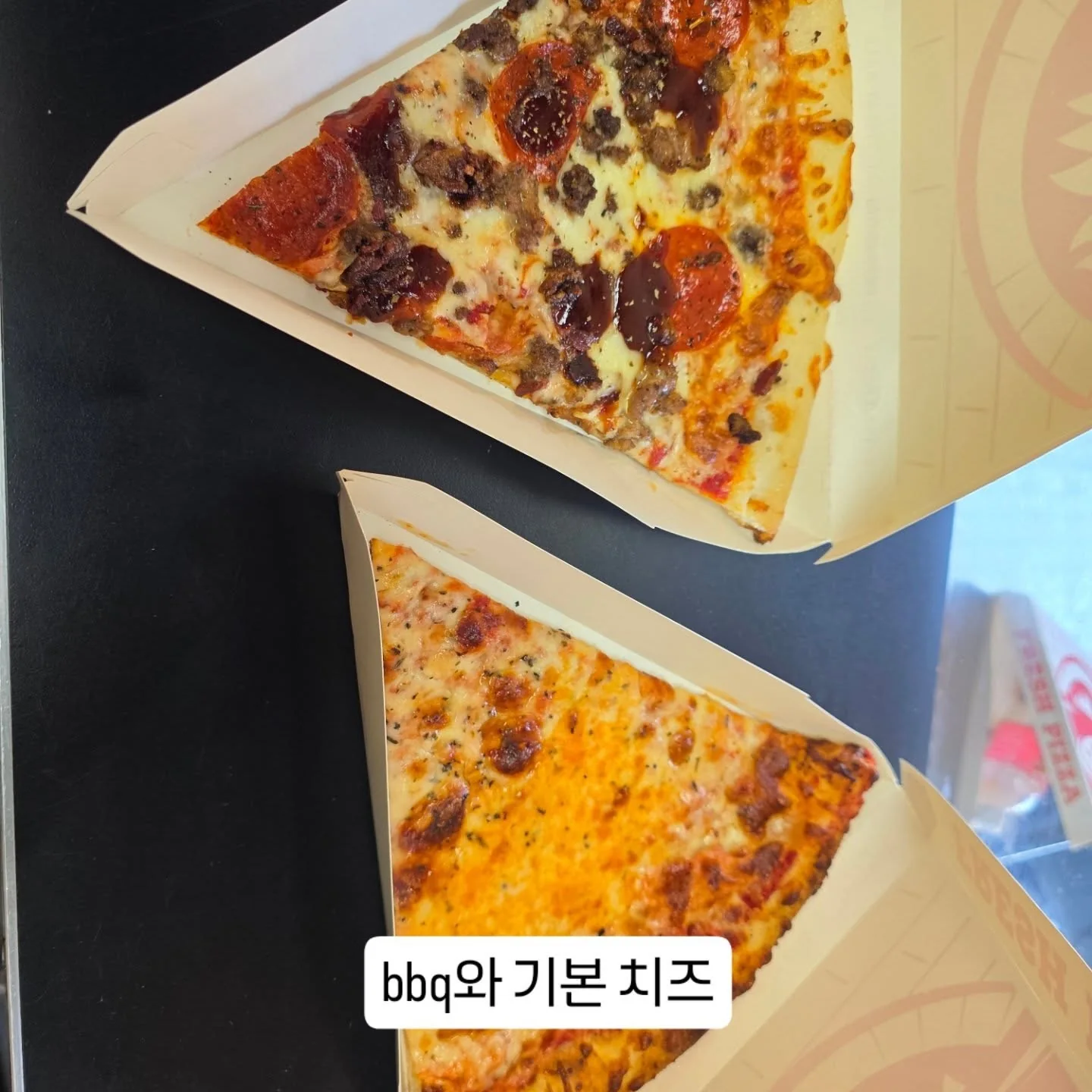 Two slices of pizza at Manolo's Pizza